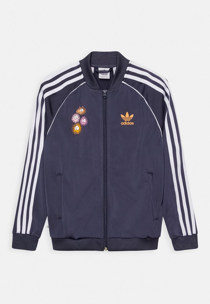 Navy blue Adidas track jacket with white stripes on sleeves, front zipper, orange Adidas logo, and colorful cartoon flower patches on left chest.