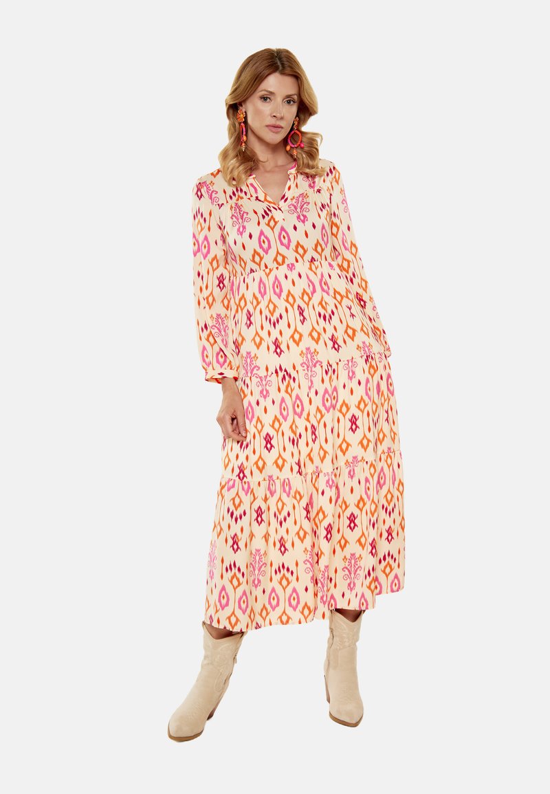 Rochie lungă, cu un model în nuanțe de roz și portocaliu; design din țesătură stratificată; accesorizată cu cizme de culoare deschisă.