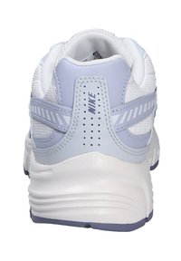 White and light gray Nike sneaker shown from the back, featuring textured mesh, stitched overlays, and a thick cushioned sole.