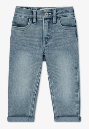 Jasnoniebieskie dżinsy z dżinsu o wąskim kroju, pięcioma kieszeniami i wywiniętymi mankietami. Posiadają zapięcie na guzik oraz subtelne wyblaknięcia.