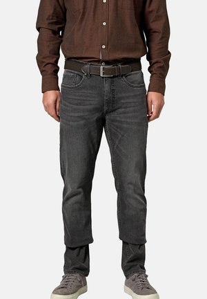 Dark gray denim jeans with a straight cut, featuring front pockets, a belt, and subtle fading. Paired with a brown button-up shirt and gray sneakers.