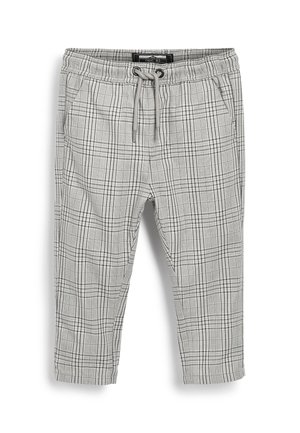 Pantalon à carreaux gris et blanc avec taille élastique et cordon de serrage, doté de poches latérales, présenté à plat sur fond blanc.