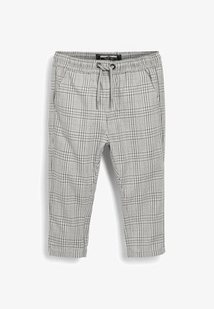 Pantalon à carreaux gris et blanc avec taille élastique et cordon de serrage, doté de poches latérales, présenté à plat sur fond blanc.