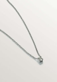Collar de cadena de plata con un colgante de zirconia cúbica en forma cuadrada, acabado pulido y patrón de eslabones, sobre un fondo claro.