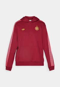 Red hoodie with pink side stripes, kangaroo pocket, and adjustable drawstring. Features Adidas logo and Germany emblem in yellow.