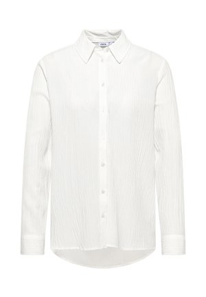 White long-sleeve shirt with a button-down front, featuring a textured fabric and a curved hem. Classic collar and single cuffs.