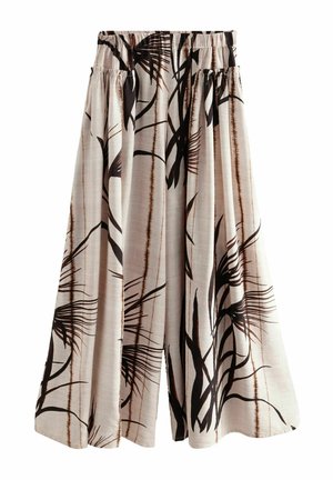 Pantalon beige à jambes larges avec un imprimé abstrait de feuilles noires et marron et une taille élastique.