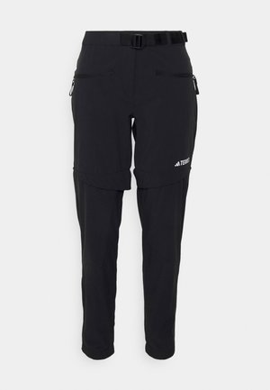 Zwarte buitenbroek met een verstelbare riem, ritszakken, taps toelopende benen en elastische boorden, ontworpen voor veelzijdigheid en comfort.