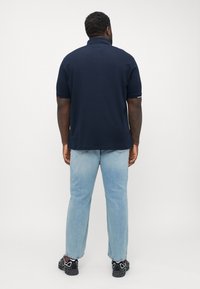 Tommy Hilfiger FLAGCUFF SLIM FIT - Polo shirt - desert sky
