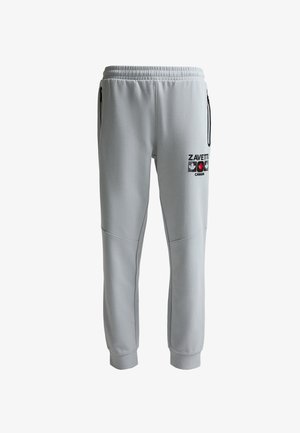 Heledast hallid püksid elastse vöökoha, lukuga küljetaskute, mansettidega pahkluude ja musta "Zavetti Canada" logoga, millel on reiel punane vahtraleht.