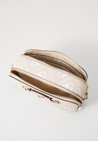 Beige zippered bag with embossed logo pattern, double compartments, gold-tone hardware, and a textured finish.