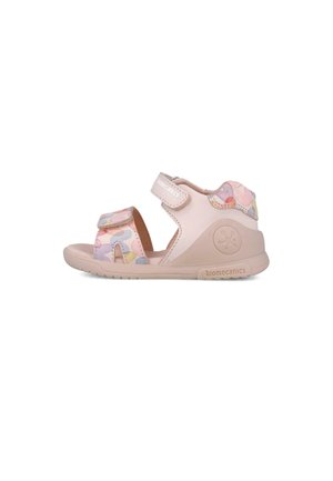 Sandalia infantil rosa con suela texturizada, correas ajustables de Velcro y un patrón abstracto colorido en la parte superior. Diseño ligero.