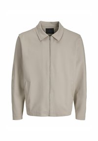 Lichtbeige jack met een rits aan de voorkant, zachte stof, een kraag en twee zijzakken. Eenvoudig ontwerp en comfortabele pasvorm.