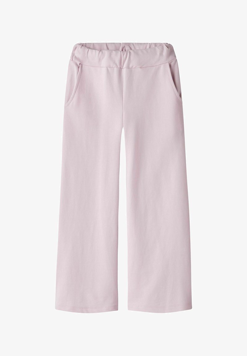 Světle růžové široké kalhoty vyrobené z měkké látky mají elastický pas a dvě boční kapsy. Hladká textura s jednoduchým designem.