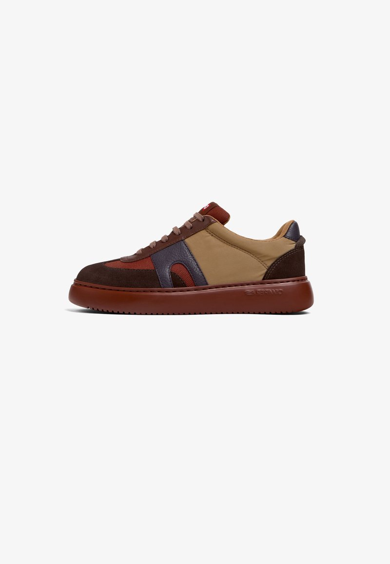 Sneakers featuring a mix of brown suede, tan fabric, and burgundy accents. Rounded toe, thick brown sole, and lace-up design.