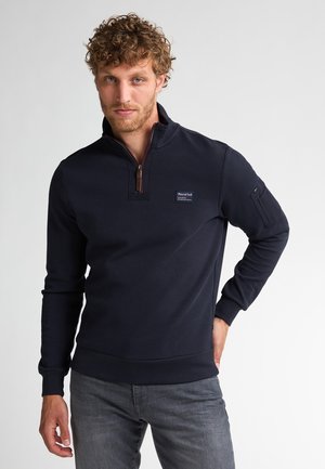 Navyblauw pullover met een ritskraag, gemaakt van katoen, met een klein logo-patch, geribde manchetten en een zijzak met een rits.