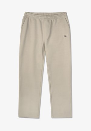 Pantalones de chándal beige hechos de una tela suave, con una cinturilla elástica, dos bolsillos laterales y un pequeño logo en el lado izquierdo.