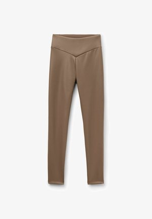 Brown, high-waisted leggings with a smooth, stretchy texture; contoured waistband design with a subtle v-shape at the front.