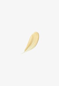 Creamy, light beige product in a smooth, elongated droplet shape with a glossy texture on a white background.