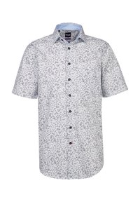 Camicetta a maniche corte di un blu chiaro con un motivo floreale bianco. Presenta una chiusura con bottoni sul davanti e un colletto standard. Realizzata in un tessuto traspirante.