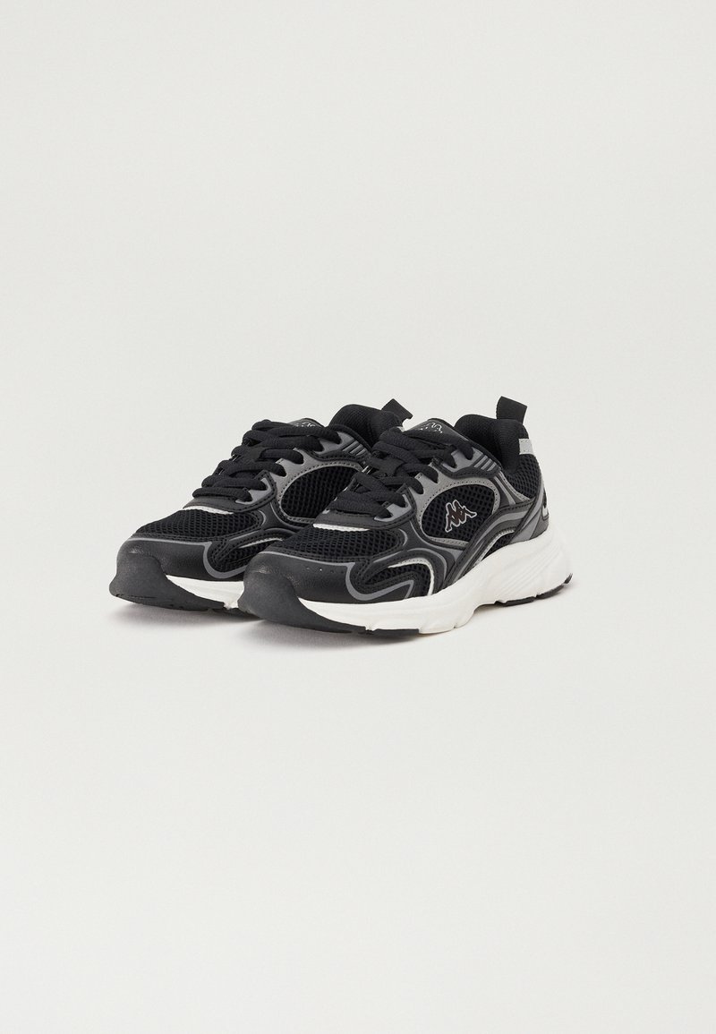 Baskets de sport noires et grises avec tige en mesh, fermeture à lacets, col rembourré et semelle blanche. Présente des accents contrastés et un détail de logo.