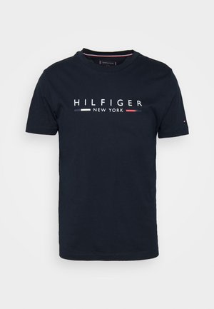 Navy blue cotton t-shirt featuring a crew neck, short sleeves, and a central white logo with red and blue accents reading "HILFIGER NEW YORK."