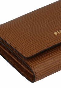 Brown textured wallet with vertical stripes, gold hardware logo, and stitched edges. Features a folding design and smooth leather finish.