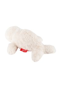 Plush toy in cream color, features soft, fluffy texture, rounded shape with short arms and legs, includes a red label.