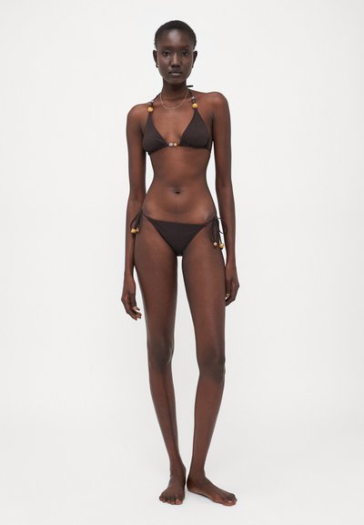Brown bikini set featuring a triangle top with bead accents, adjustable ties on the hips, and a minimalist design.