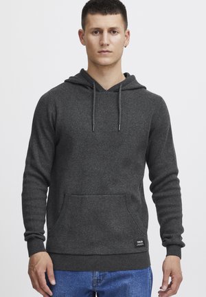 Sudadera gris con un bolsillo frontal, capucha ajustable con cordón, puños y dobladillo acanalados. Hecha de una tela suave y texturizada.