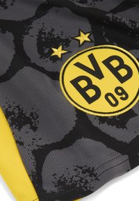 Tricou sportiv gri cu un model abstract negru, un logo circular galben cu textul negru "BVB 09" și două stele galbene deasupra logo-ului.