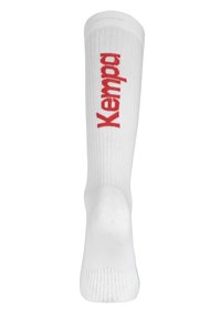 Calzino bianco al ginocchio con texture a coste, dotato di logo rosso "Kempa" stampato verticalmente sul davanti, materiale morbido e tallone rinforzato.