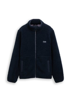 Giacca in pile blu navy scuro con zip integrale, collo alto, due tasche frontali e piccolo logo "TL62" sul petto sinistro.