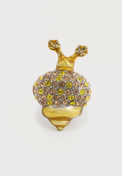 Pièce décorative en résine jaune et transparente en forme de gland, ornée de strass ronds brun et jaune, avec deux petits accents de tige.