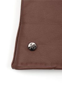 Brown leather wallet with textured surface and visible stitching. Features a circular metal logo accent in silver.