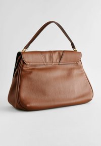 Sac à main en cuir marron avec un design structuré, mettant en avant une poignée supérieure, des coutures discrètes et une finition lisse et texturée.