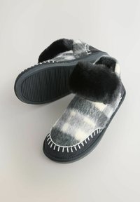 Gray and cream patterned slippers with faux fur trim and black rubber sole. Features decorative white stitching and a rounded shape.