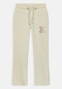 Calças de moletom bege claro feitas de tecido suave, com um cós ajustável, dois bolsos laterais e um logotipo tecido em rosa numa perna.
