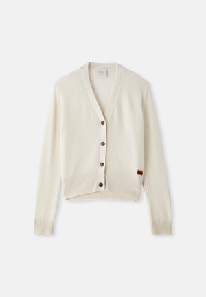 Cream-colored cardigan with a V-neck, ribbed cuffs, and hem. Features five dark buttons and a small rainbow stripe detail on the hem.