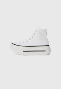 White high-top sneakers with a canvas upper, rubber sole, black stripe detail, and lace-up closure. Textured sole for added grip.