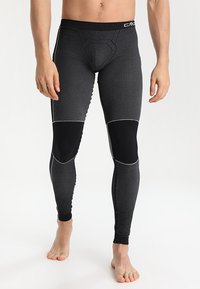 Leggings de compresión en gris oscuro con acentos en negro. Fabricadas con una tela elástica que presenta una textura acanalada y detalles de panel contrastantes.