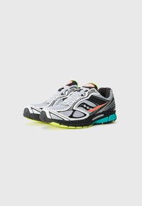 Pair of white, black, and neon green running shoes with orange accents, mesh uppers, and cushioned soles on a gray background.