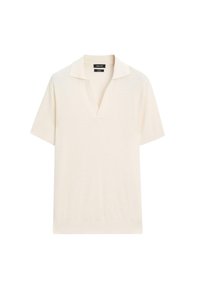 Kortærmet polo-shirt i cremefarvet strikket stof med en tekstureret overflade, der har en klassisk krave og en afslappet pasform.