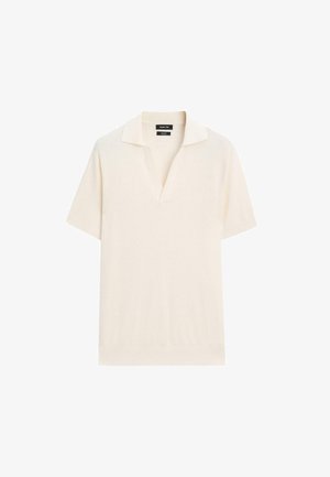 Kortekoo polo shirt in crèmekleurige brei stof met een gestructureerde afwerking, voorzien van een klassieke kraag en een ontspannen pasvorm.