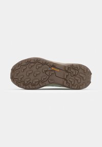 Semelle en caoutchouc marron avec des crampons profonds et anguleux et un petit logo orange "Continental" au centre, conçue pour la traction extérieure.