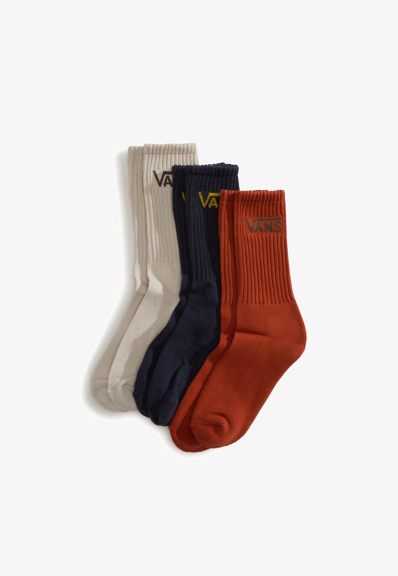 Tres pares de calcetines de tripulación: beige claro, azul marino y naranja óxido. Textura acanalada con el logo "VANS" en colores contrastantes en cada par.