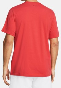 Červené tričko s krátkým rukávem vyrobené z měkké tkaniny. Má kulatý výstřih a malé logo na horní části zad. Hladká textura a pohodlný střih.