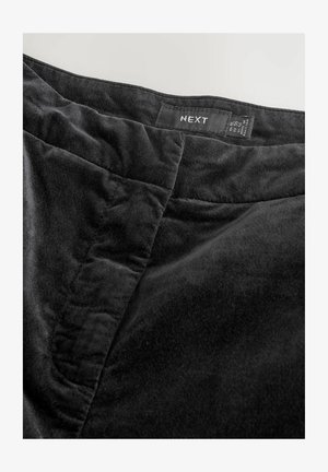 Juodas aksominis sijonas su lygiu paviršiumi, su siuvinėtomis siūlėmis ir etiketė, nurodanti prekės ženklą 'NEXT' ant juosmens.