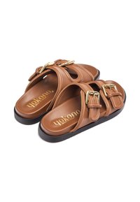 Brown leather slide sandals featuring two adjustable gold buckle straps, a rounded shape, and a cushioned insole with a black rubber sole.