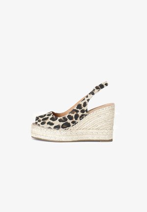 Leopard print espadrille wedge shoe with an open toe, tan inner lining, and a braided jute platform. Adjustable slingback strap for fit.